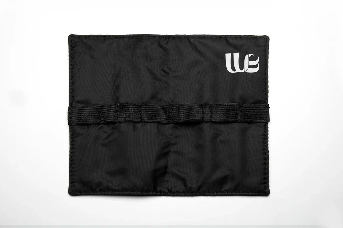 Inside of the Wisnewski Magnetic Pouch. Black fabric with an elastic band to place tools. There's a white Wisnewski logo in the top right corner. 