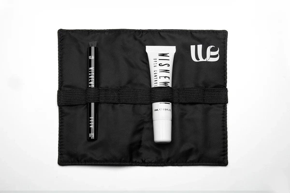 Inside view of the Wisnewski Complete Brow kit. Features the black inside of a magnetic pouch with an elastic band in the middle. The kit also contains a #9 Eyebrow Brush and a white tube of the Extra Strong Control Gel for eyebrows. 